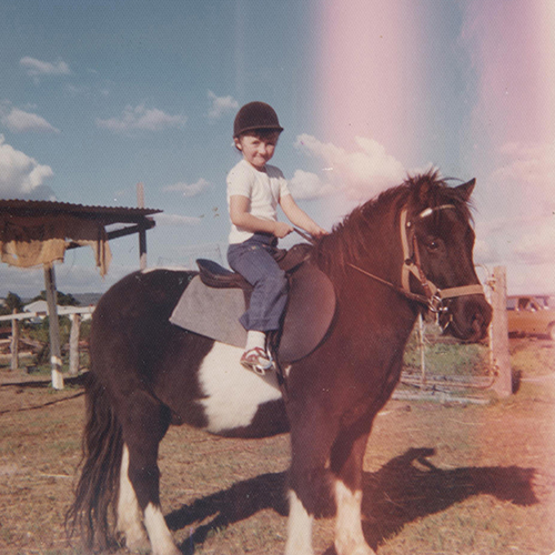 About me photo - riding my horse as a child