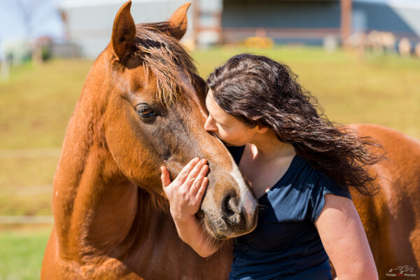 Woman kissing horse - lifestyle equestrian photography